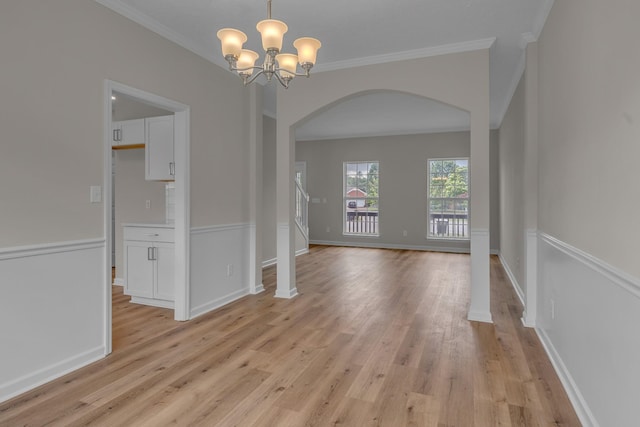 408 Jordan Leigh Ct, Joelton, TN 37080 - spare room featuring arched walkways, light wood-type flooring, a chandelier, crown molding, and baseboards