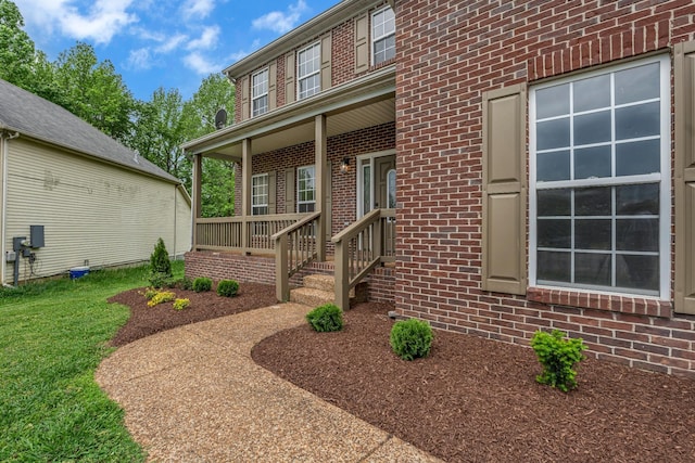 408 Jordan Leigh Ct, Joelton, TN 37080 - doorway to property featuring brick siding, covered porch, and a yard