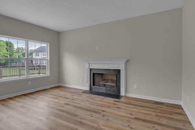408 Jordan Leigh Ct, Joelton, TN 37080 - unfurnished living room featuring wood finished floors, a fireplace with flush hearth, and baseboards