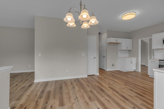 408 Jordan Leigh Ct, Joelton, TN 37080 - kitchen with a chandelier, light wood-type flooring, light countertops, and white cabinetry