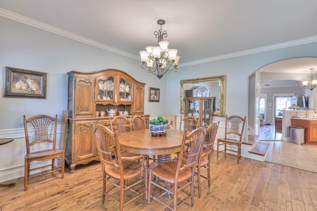 236 Danoher Walk, Murfreesboro, TN 37128 - dining space featuring a chandelier, arched walkways, light wood finished floors, and ornamental molding