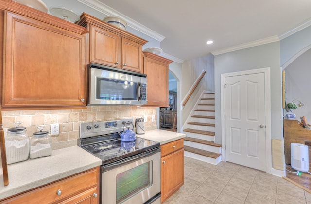 236 Danoher Walk, Murfreesboro, TN 37128 - kitchen with stainless steel appliances, arched walkways, ornamental molding, decorative backsplash, and light tile patterned floors