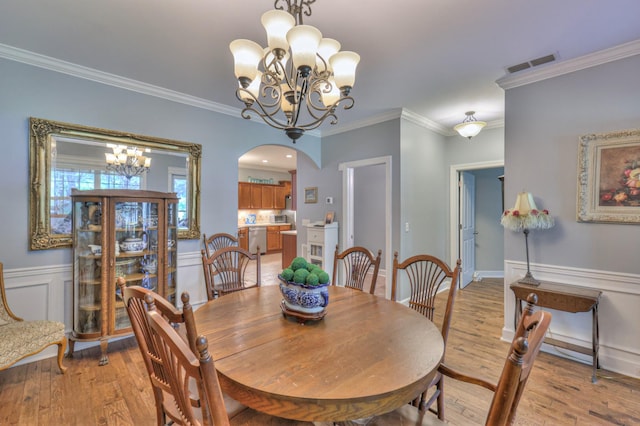 236 Danoher Walk, Murfreesboro, TN 37128 - dining area with a chandelier, arched walkways, crown molding, and light wood-style floors