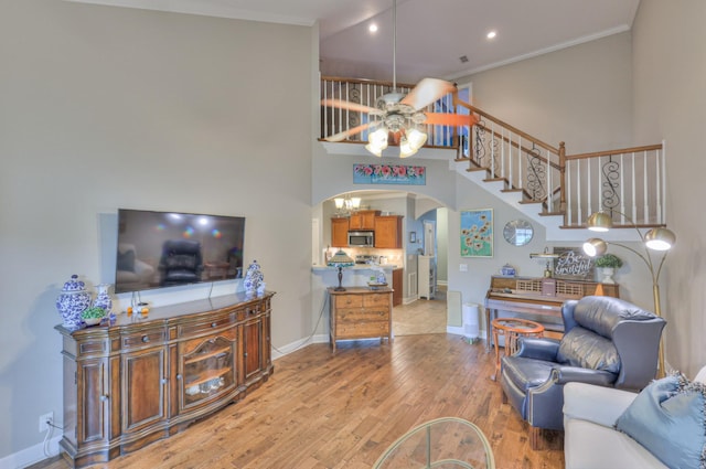 236 Danoher Walk, Murfreesboro, TN 37128 - living area with arched walkways, baseboards, wood finished floors, a ceiling fan, and crown molding