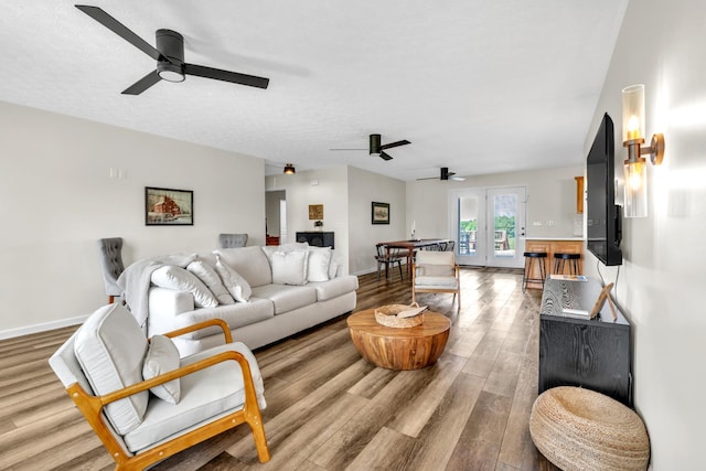 5440 Eugene Kennedy Ln, Cedar Hill, TN 37032 - living area featuring a ceiling fan, french doors, wood finished floors, and baseboards