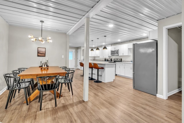 5440 Eugene Kennedy Ln, Cedar Hill, TN 37032 - dining space featuring baseboards, light wood-style flooring, and a chandelier