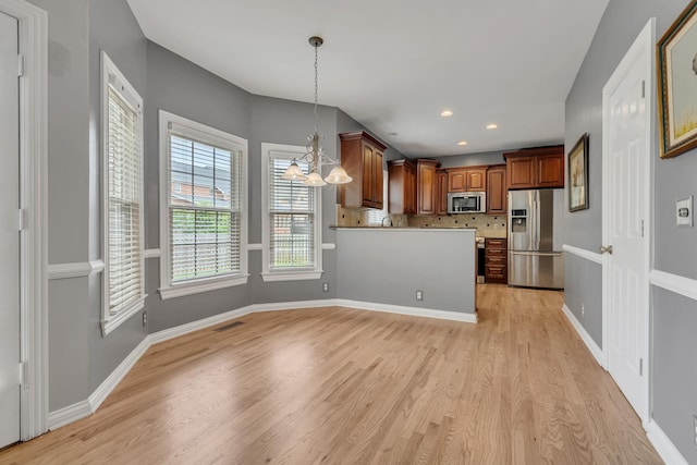 308 Stanley Park Ln, Franklin, TN 37069 - kitchen featuring appliances with stainless steel finishes, a chandelier, light wood finished floors, pendant lighting, and recessed lighting