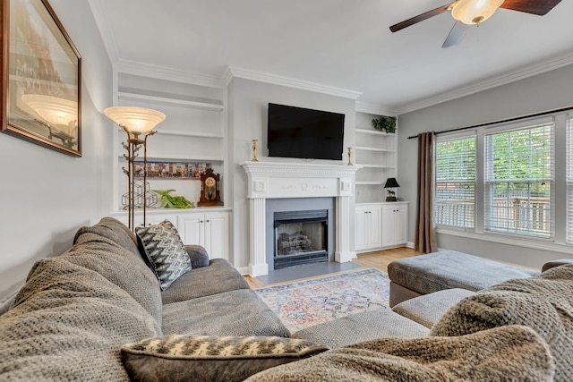 308 Stanley Park Ln, Franklin, TN 37069 - living area featuring a ceiling fan, ornamental molding, wood finished floors, a fireplace with flush hearth, and built in shelves