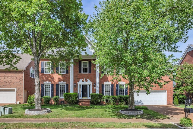 308 Stanley Park Ln, Franklin, TN 37069 - view of front facade with brick siding, asphalt driveway, a front yard, and a garage