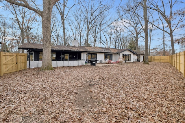 512 Westwood Dr, Tullahoma, TN 37388 - back of property with a chimney, a gate, and a fenced backyard