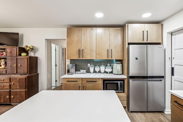 512 Westwood Dr, Tullahoma, TN 37388 - kitchen featuring stainless steel appliances, light countertops, wood finished floors, backsplash, and recessed lighting