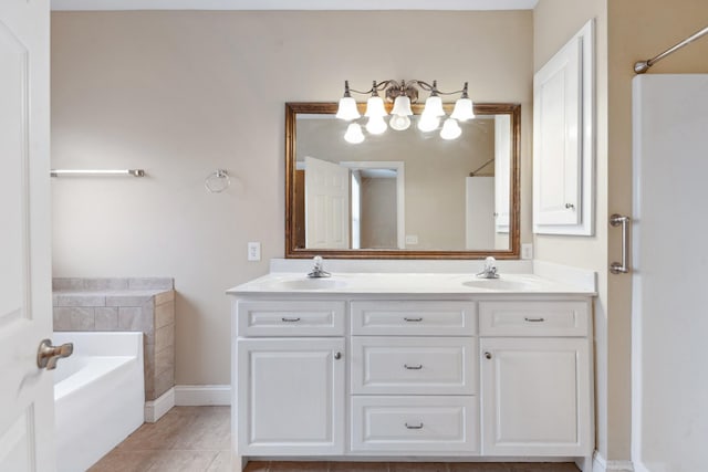 bathroom featuring a bath, tile patterned floors, double vanity, and baseboards