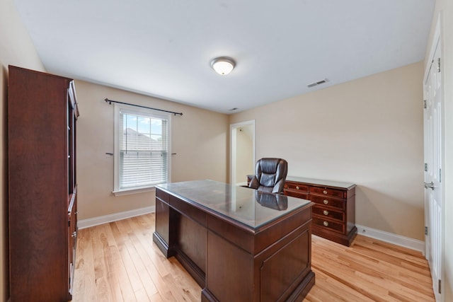 office area with light wood-style floors and baseboards