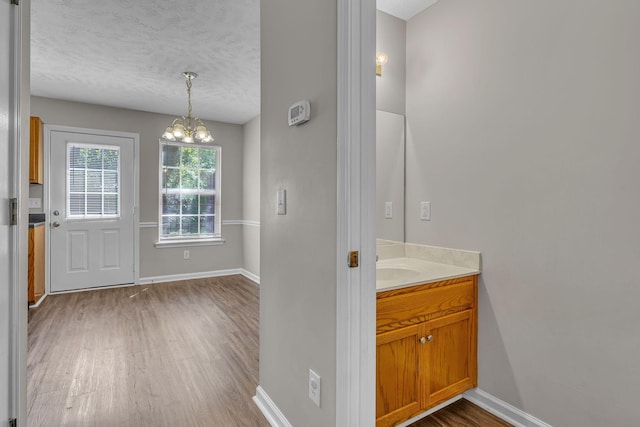 1514 Center Pointe Dr, Murfreesboro, TN 37130 - bathroom featuring wood finished floors, a chandelier, baseboards, vanity, and a textured ceiling