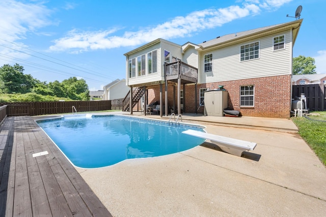 845 Nandina Ct, Clarksville, TN 37043 - view of swimming pool with a wooden deck, a patio, stairs, a fenced backyard, and a diving board