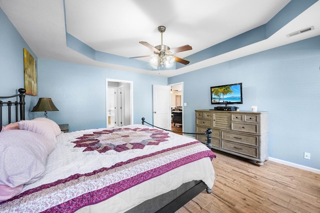 845 Nandina Ct, Clarksville, TN 37043 - bedroom with light wood-style flooring, baseboards, a tray ceiling, and ceiling fan