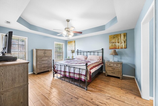 845 Nandina Ct, Clarksville, TN 37043 - bedroom with a raised ceiling, light wood-style flooring, and baseboards