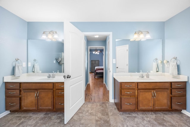 845 Nandina Ct, Clarksville, TN 37043 - bathroom featuring two vanities, baseboards, connected bathroom, and a ceiling fan