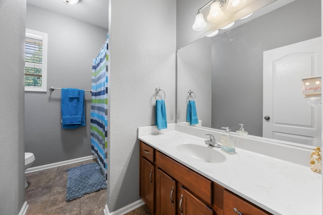 845 Nandina Ct, Clarksville, TN 37043 - full bathroom with vanity, toilet, stone finish flooring, baseboards, and a shower with shower curtain