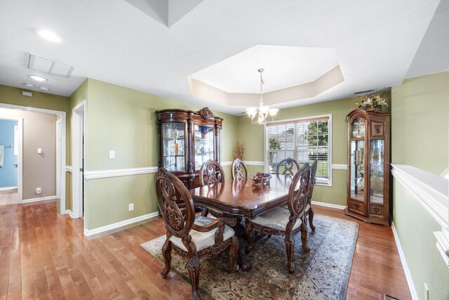 845 Nandina Ct, Clarksville, TN 37043 - dining room featuring light wood-type flooring, a chandelier, baseboards, a tray ceiling, and recessed lighting