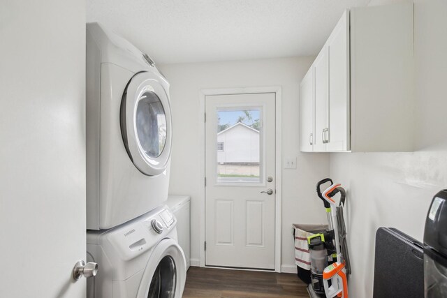 976 Long Beech Dr, Clarksville, TN 37042 - washroom with stacked washing machine and dryer, dark wood-style flooring, cabinet space, and baseboards