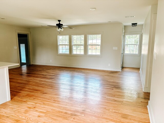 400 Circle Dr, Estill Springs, TN 37330 - empty room with healthy amount of natural light, ceiling fan, light wood-style floors, and baseboards