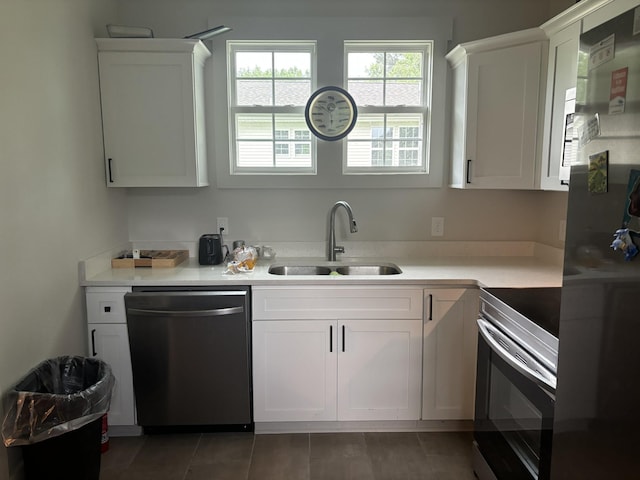400 Circle Dr, Estill Springs, TN 37330 - kitchen with dishwashing machine, stainless steel electric range, a sink, white cabinets, and light countertops