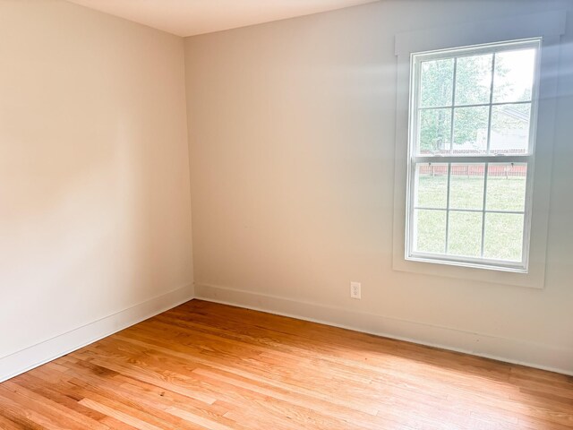 400 Circle Dr, Estill Springs, TN 37330 - empty room with healthy amount of natural light, light wood finished floors, and baseboards