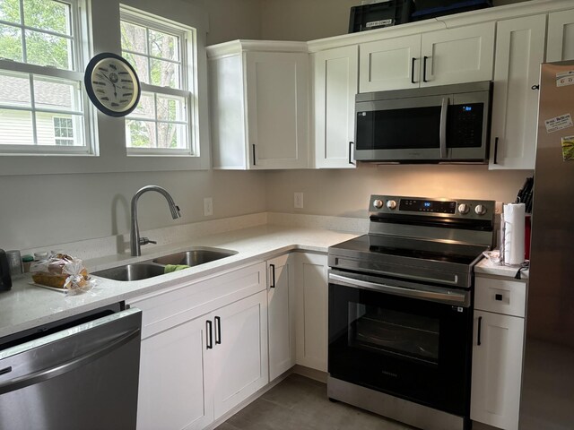 400 Circle Dr, Estill Springs, TN 37330 - kitchen featuring stainless steel appliances, a sink, light countertops, and white cabinets