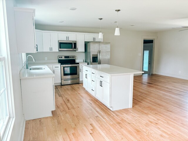 400 Circle Dr, Estill Springs, TN 37330 - kitchen featuring stainless steel appliances, a sink, light countertops, and light wood-type flooring