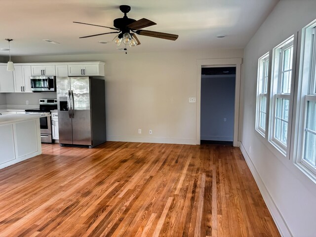 400 Circle Dr, Estill Springs, TN 37330 - kitchen featuring stainless steel appliances, light wood-style floors, light countertops, ceiling fan, and white cabinets