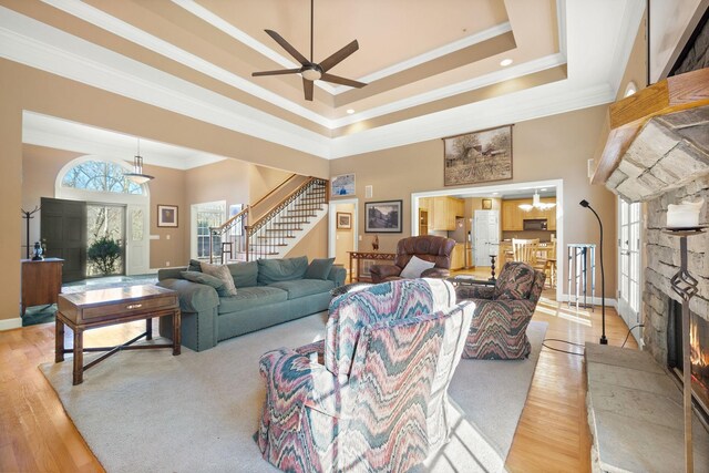 1130 Crater Hill Dr, Nashville, TN 37215 - living room with a stone fireplace, crown molding, stairs, ceiling fan, and a towering ceiling