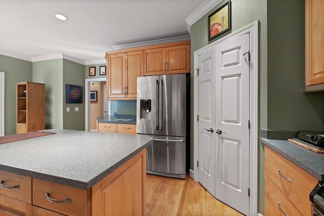1130 Crater Hill Dr, Nashville, TN 37215 - kitchen with stainless steel fridge, crown molding, light wood-style floors, a center island, and dark countertops