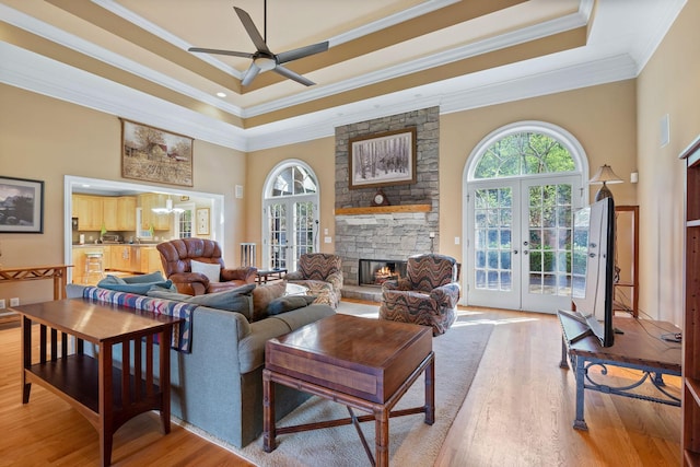1130 Crater Hill Dr, Nashville, TN 37215 - living room featuring a raised ceiling, crown molding, a ceiling fan, french doors, and wood finished floors