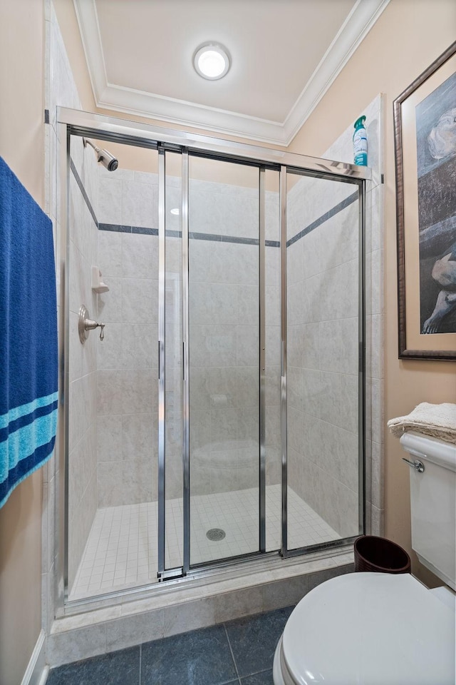 1130 Crater Hill Dr, Nashville, TN 37215 - bathroom with toilet, ornamental molding, a stall shower, and tile patterned flooring