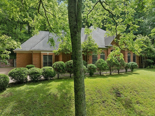 1130 Crater Hill Dr, Nashville, TN 37215 - obstructed view of property with brick siding, a shingled roof, and a front yard