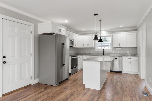 7959 Monterey Hwy, Sparta, TN 38583 - kitchen with appliances with stainless steel finishes, a sink, ornamental molding, white cabinetry, and dark wood finished floors