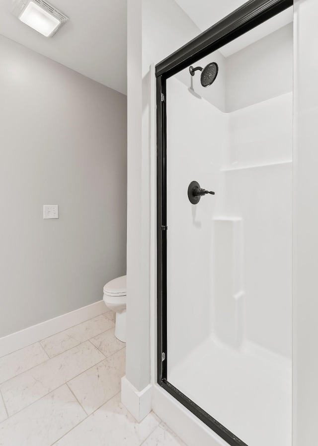 7959 Monterey Hwy, Sparta, TN 38583 - bathroom featuring marble finish floors, a stall shower, baseboards, and toilet
