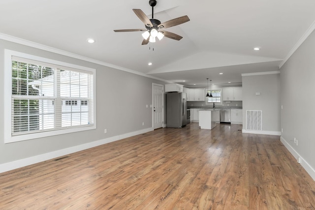 7959 Monterey Hwy, Sparta, TN 38583 - unfurnished living room with crown molding, a ceiling fan, light wood finished floors, lofted ceiling, and baseboards