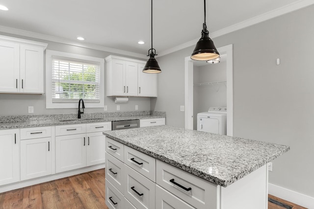 7959 Monterey Hwy, Sparta, TN 38583 - kitchen with washer / dryer, ornamental molding, a sink, hanging light fixtures, and stainless steel dishwasher