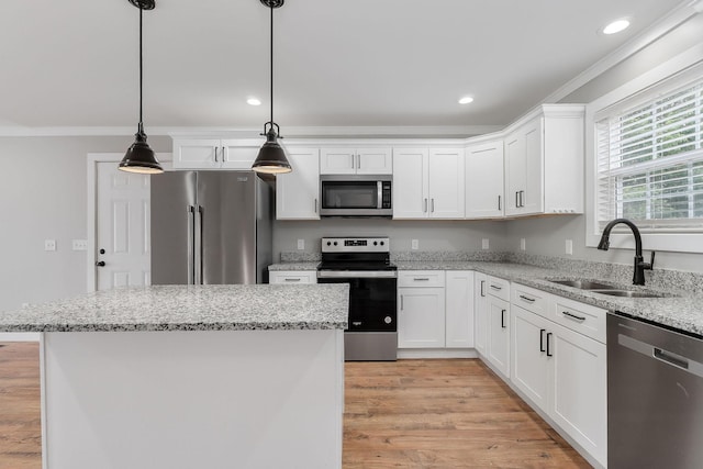 7959 Monterey Hwy, Sparta, TN 38583 - kitchen with appliances with stainless steel finishes, a sink, ornamental molding, white cabinetry, and light wood finished floors