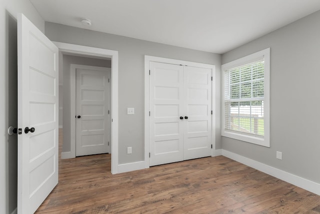 7959 Monterey Hwy, Sparta, TN 38583 - unfurnished bedroom featuring baseboards, wood finished floors, and a closet