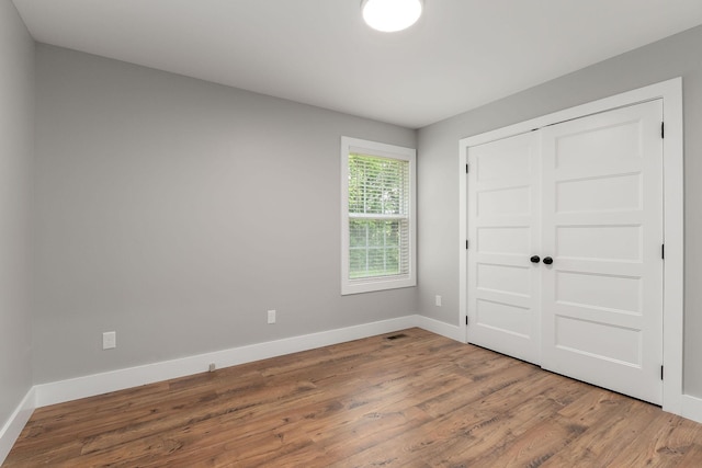 7959 Monterey Hwy, Sparta, TN 38583 - unfurnished bedroom with wood finished floors, baseboards, and a closet