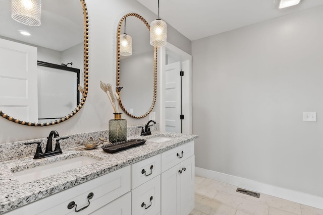 7959 Monterey Hwy, Sparta, TN 38583 - bathroom featuring baseboards, double vanity, and marble look tile flooring