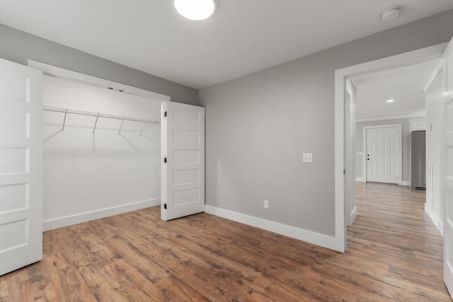 7959 Monterey Hwy, Sparta, TN 38583 - unfurnished bedroom featuring wood finished floors, baseboards, a closet, and recessed lighting