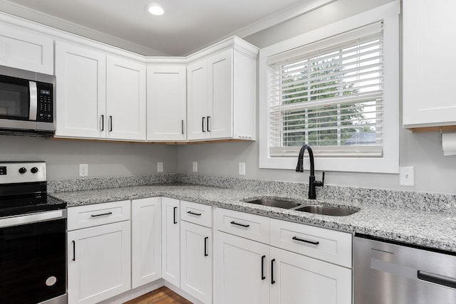 7959 Monterey Hwy, Sparta, TN 38583 - kitchen with appliances with stainless steel finishes, a sink, white cabinetry, light stone counters, and recessed lighting