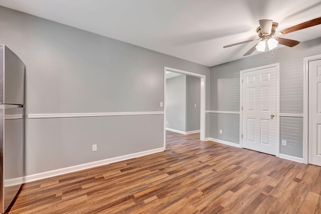 2290 Petway Rd, Ashland City, TN 37015 - unfurnished bedroom with freestanding refrigerator, baseboards, wood finished floors, and a ceiling fan