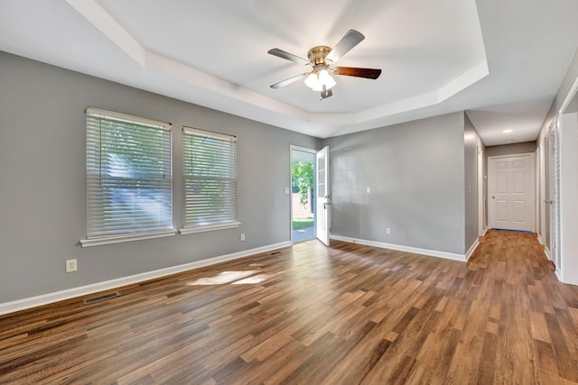 2290 Petway Rd, Ashland City, TN 37015 - spare room featuring a tray ceiling, ceiling fan, wood finished floors, and baseboards