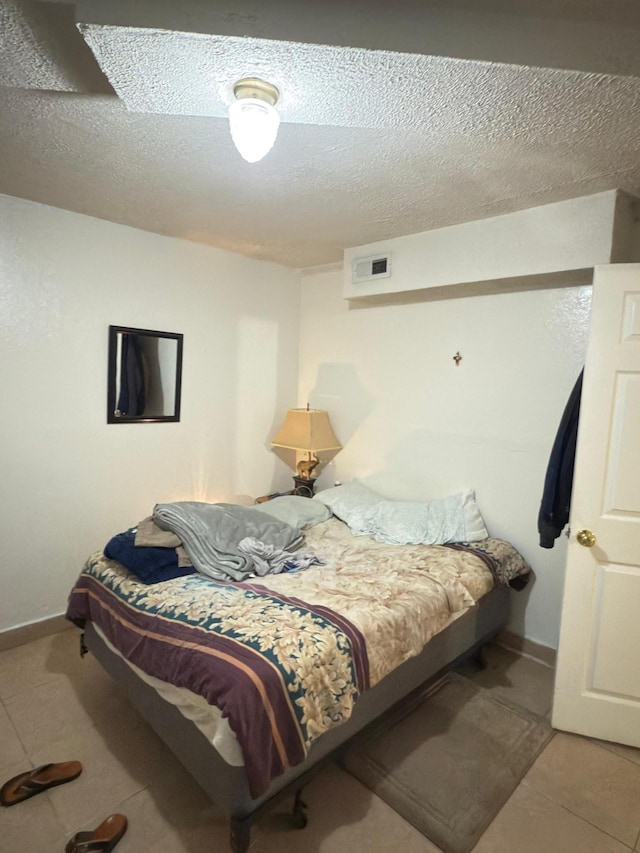 438 Tampa Dr, Nashville, TN 37211 - tiled bedroom featuring a textured ceiling and baseboards