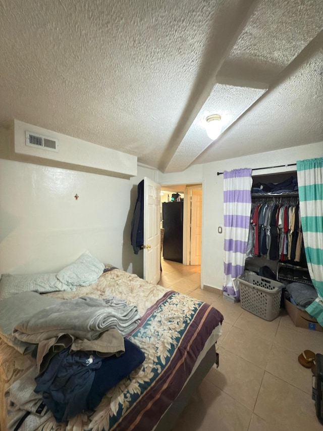 438 Tampa Dr, Nashville, TN 37211 - bedroom featuring a textured ceiling, light tile patterned floors, and a closet